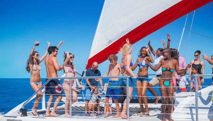 Montego Bay: Reggae Family Catamaran Cruise with Snorkeling - Leaving Montego Bay with hotel pickup